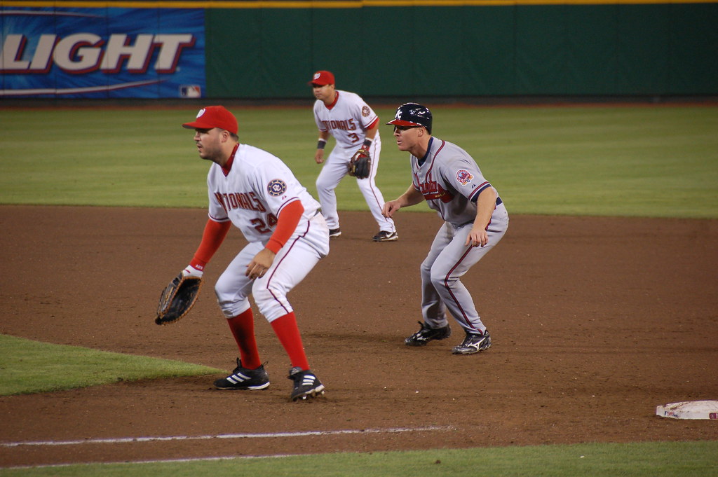 Washington Nationals Nick Johnson holds Atlanta Braves Pete Orr at first base