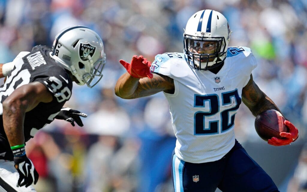 Tennessee Titans running back Derrick Henry (22) is set to push off Oakland Raiders strong safety T.J. Carrie (38) at Nissan Stadium in Nashville on Sept. 10, 2017. The Titans lost their home and season opener 26-16.