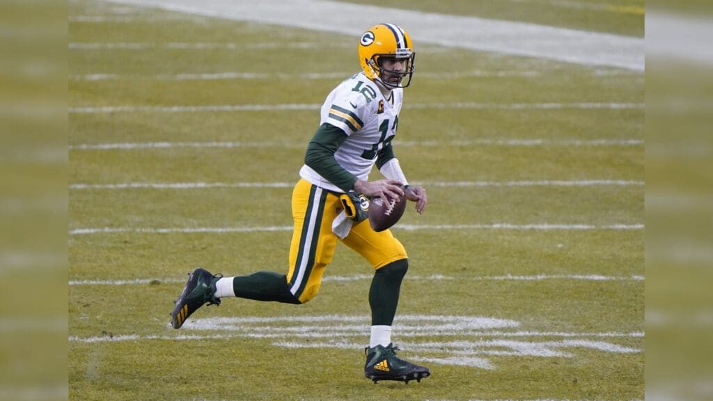 Jan 3, 2021; Chicago, Illinois, USA; Green Bay Packers quarterback Aaron Rodgers (12) rushes the ball against the Chicago Bears during the first quarter at Soldier Field.