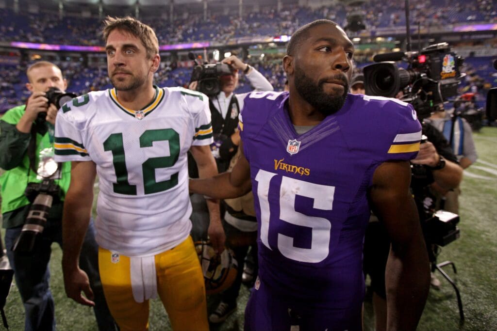 Oct 27, 2013; Minneapolis, MN, USA; Minnesota Vikings wide receiver Greg Jennings (15) talks with Green Bay Packers quarterback Aaron Rodgers (12) following the game at Mall of America Field at H.H.H. Metrodome. The Packers defeated the Vikings 44-31.