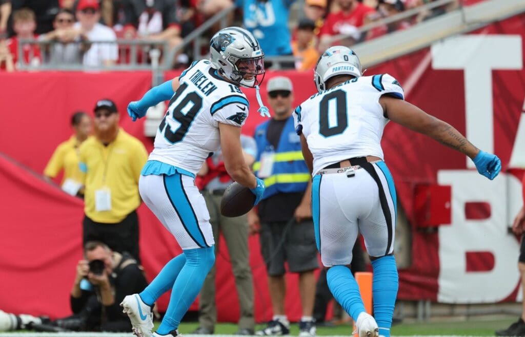 Dec 29, 2024; Tampa, Florida, USA; Carolina Panthers wide receiver Adam Thielen (19) is congratulated by tight end Ja'Tavion Sanders (0) after he scored a touchdown against the Tampa Bay Buccaneers during the first quarter at Raymond James Stadium.