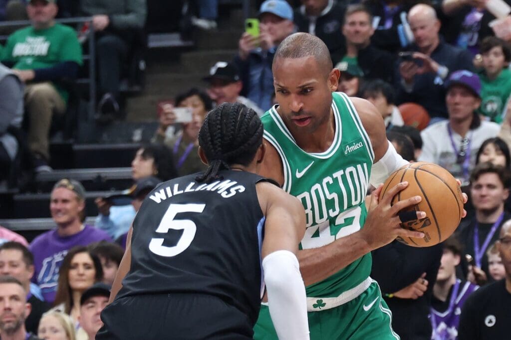 Mar 21, 2025; Salt Lake City, Utah, USA; Boston Celtics center Al Horford (42) looks for a play as Utah Jazz forward Cody Williams (5) defends during the first half at Delta Center. Mandatory Credit: Rob Gray-Imagn Images