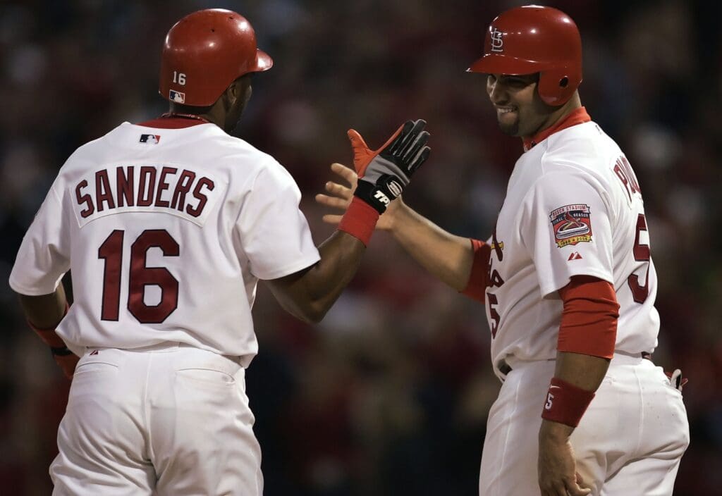 Sept. 28, 2005; St. Louis, MO, USA; Outfielder Reggie Sanders #16 of the St. Louis Cardinals is congratulated by teammate first baseman Albert Pujols #5 after Sanders hit a two-run home run against the Houston Astros at Busch Stadium.