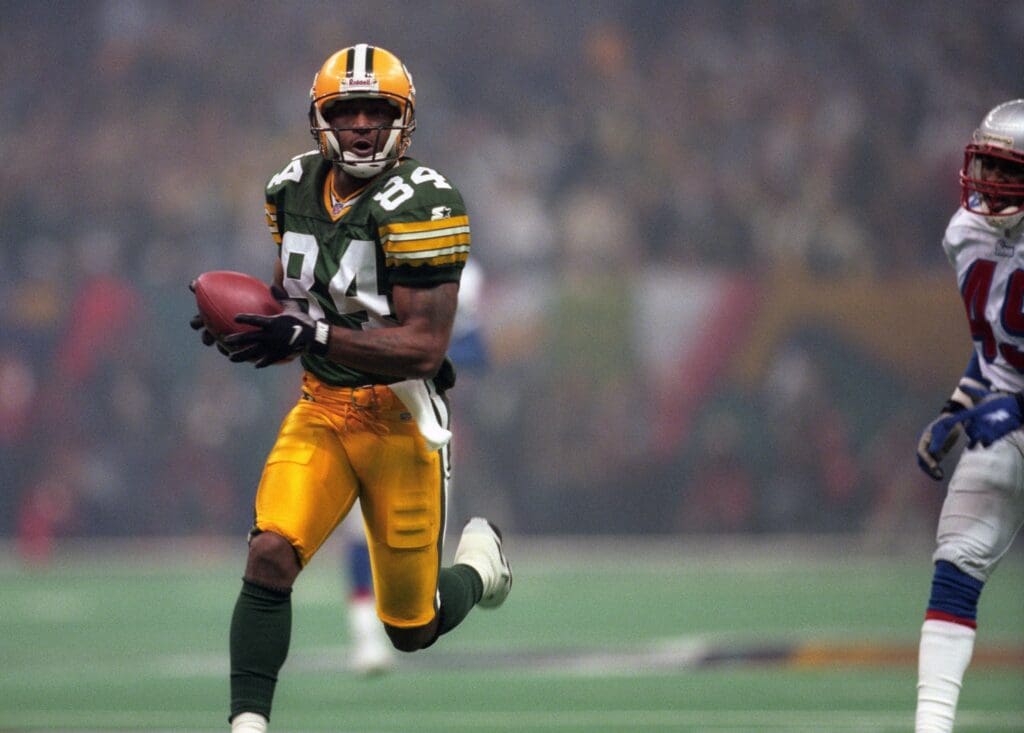 Jan 26, 1997; New Orleans, LA, USA; FILE PHOTO; Green Bay Packers receiver Andre Rison (84) catches a pass for a touchdown reception against the New England Patriots during Super Bowl XXXI at the Superdome. The Packers defeated the Patriots 35-21.
