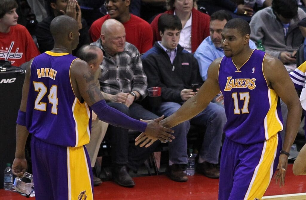 Andrew Bynum slaps hands with teammate Kobe Bryant.