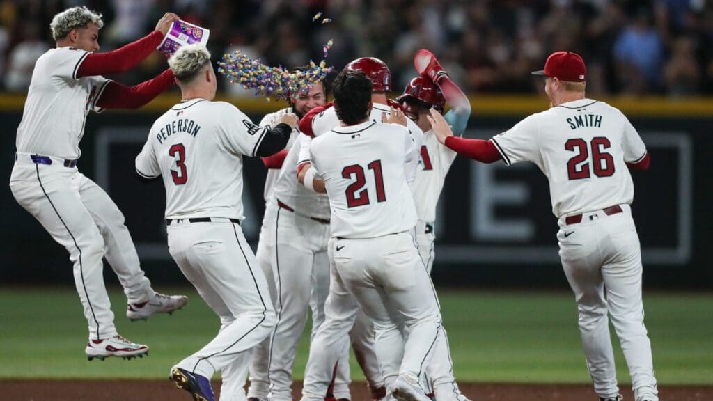 Arizona Diamondbacks third base Eugenio Suarez (28) is mobbed by teammates after his walk-off hit on Sept. 15, 2024 at Chase Field in Phoenix