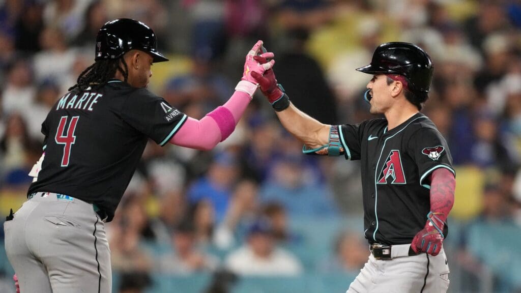 May 20, 2025; Los Angeles, California, USA; Arizona Diamondbacks right fielder Corbin Carroll (7) celebrates with second baseman Ketel Marte (4) after hitting a two-run home run in the 10th inning against the Los Angeles Dodgers at Dodger Stadium.
