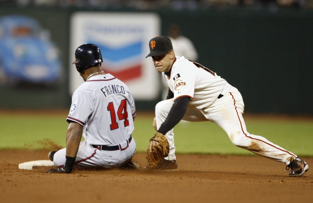 Jul 24, 2007; San Francisco, CA, USA; Atlanta Braves first baseman Julio Franco (14) slides safely into second base past San Francisco Giants shortstop Omar Vizquel (13) after hitting a double during the eighth inning at AT&T Park in San Francisco, CA.