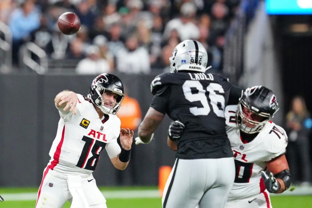 Dec 16, 2024; Paradise, Nevada, USA; Atlanta Falcons quarterback Kirk Cousins (18) passes the ball against the Las Vegas Raiders during the second quarter at Allegiant Stadium. 