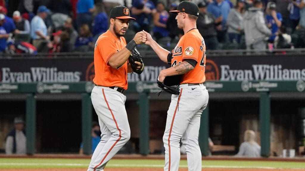 Apr 17, 2021; Arlington, Texas, USA; Baltimore Orioles right fielder Anthony Santander (25) and relief pitcher Shawn Armstrong (43) celebrate their teams win against the Texas Rangers at Globe Life Field. The Orioles won 6-1.