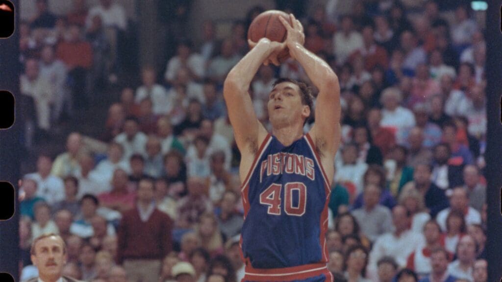 06/10/1990, Portland, Oregon, USA; Pistons' Bill Laimbeers shoots the ball toward the net with the Trailblazers' Coach in the background in the third game of the NBA Finals,