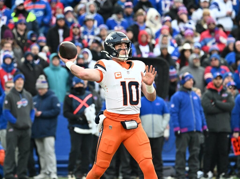Jan 12, 2025; Orchard Park, New York, USA; Denver Broncos quarterback Bo Nix (10) throws downfield during the fourth quarter against the Buffalo Bills in an AFC wild card game at Highmark Stadium.