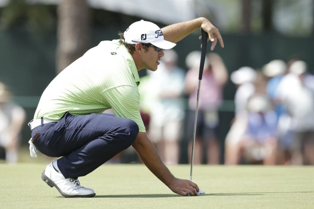Jun 14, 2014; Pinehurst, NC, USA; Brooks Koepka lines up his putt on the third green during the third round of the 2014 U.S. Open golf tournament at Pinehurst Resort Country Club - #2 Course.