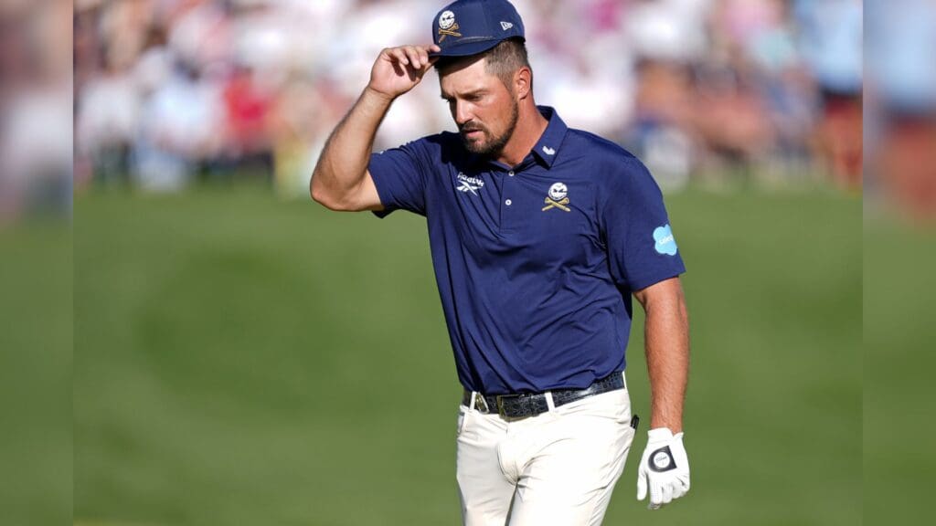 May 18, 2025; Charlotte, North Carolina, USA; Bryson DeChambeau acknowledges fans while walking on the 18th green during the final round of the PGA Championship golf tournament at Quail Hollow.