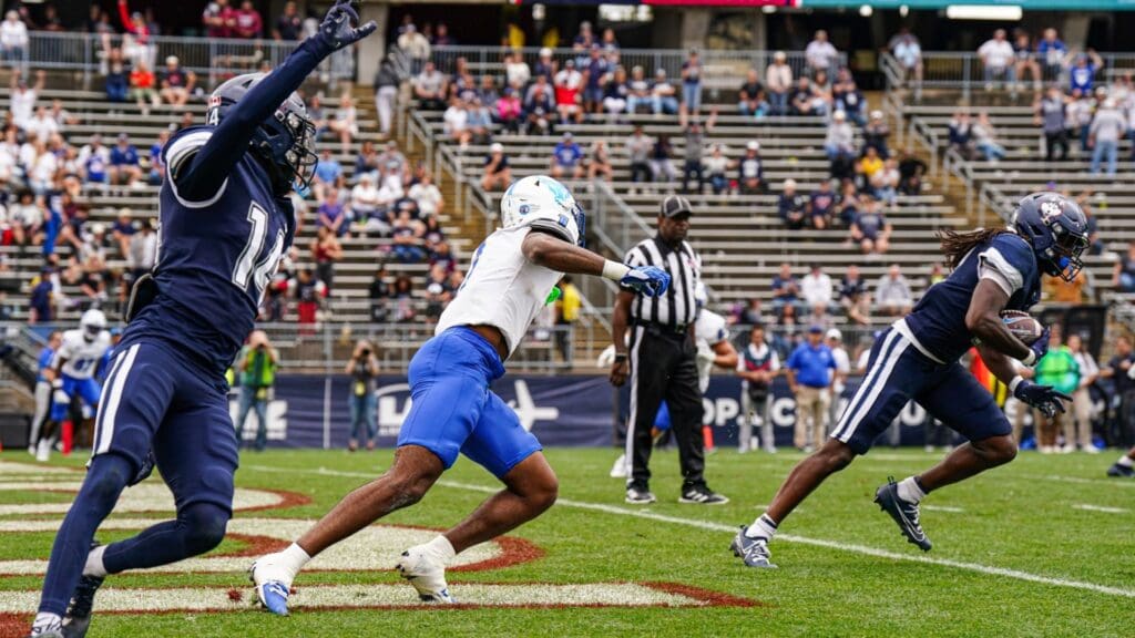 Connecticut Huskies defensive back Rante Jones (2) intercepts a pass intended for Buffalo Bulls wide receiver Qua Sanders (1) in the second half at Rentschler Field at Pratt & Whitney Stadium.