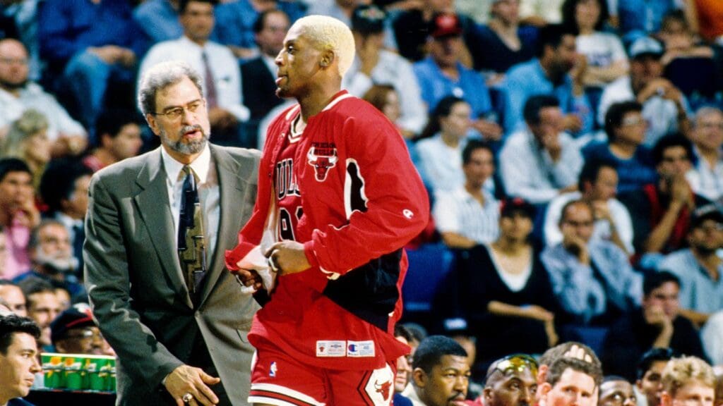 Chicago Bulls head coach Phil Jackson and forward Dennis Rodman talk on the sidelines against the Miami Heat during the first round of the 1996 NBA Playoffs at the Miami Arena.