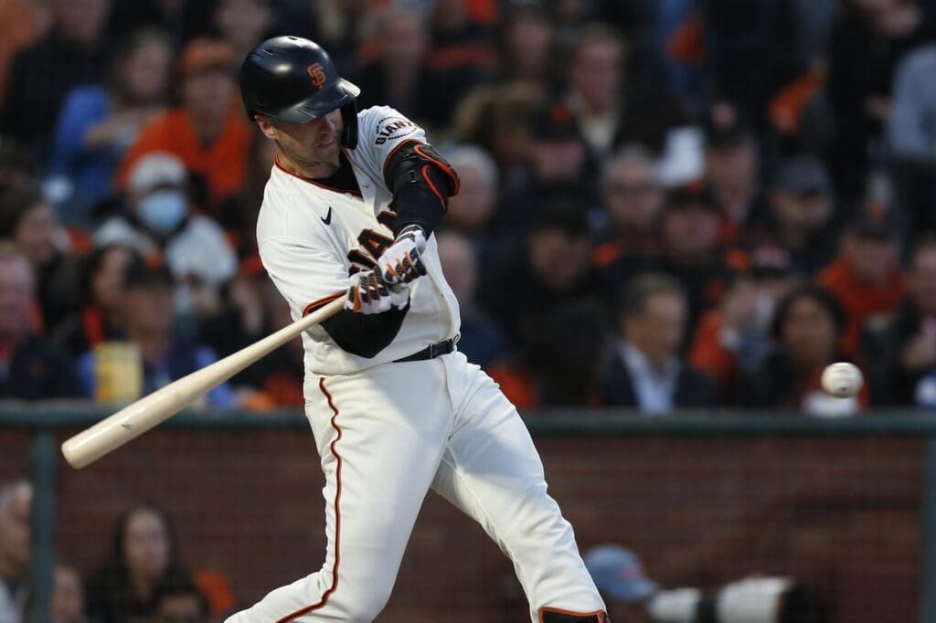 Oct 14, 2021; San Francisco, California, USA; San Francisco Giants catcher Buster Posey (28) hits a double against the Los Angeles Dodgers in the first inning during game five of the 2021 NLDS at Oracle Park.