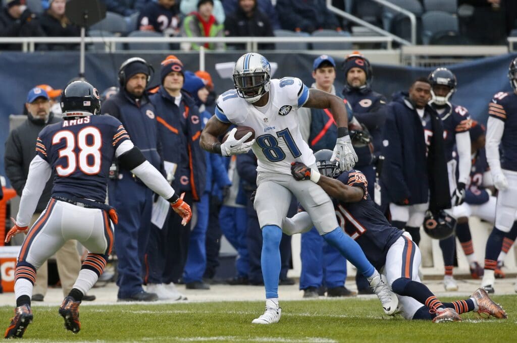 Jan 3, 2016; Chicago, IL, USA; Detroit Lions wide receiver Calvin Johnson (81) is tackled by Chicago Bears strong safety Ryan Mundy (21) during the first half at Soldier Field. Mandatory Credit: Kamil Krzaczynski-USA TODAY Sports