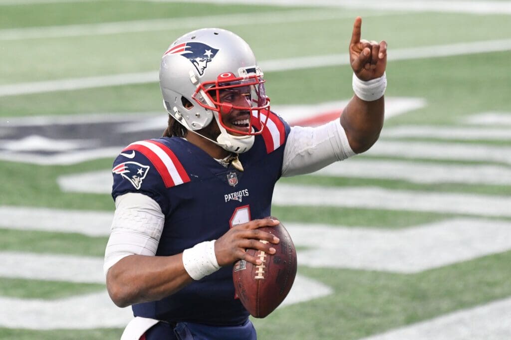 Jan 3, 2021; Foxborough, Massachusetts, USA; New England Patriots quarterback Cam Newton (1) celebrates after scoring a touchdown against the New York Jets during the third quarter at Gillette Stadium.