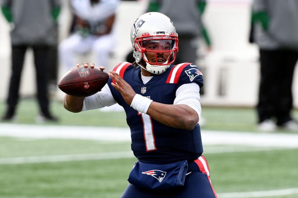 Jan 3, 2021; Foxborough, Massachusetts, USA; New England Patriots quarterback Cam Newton (1) looks to pass against the New York Jets during the first quarter at Gillette Stadium.