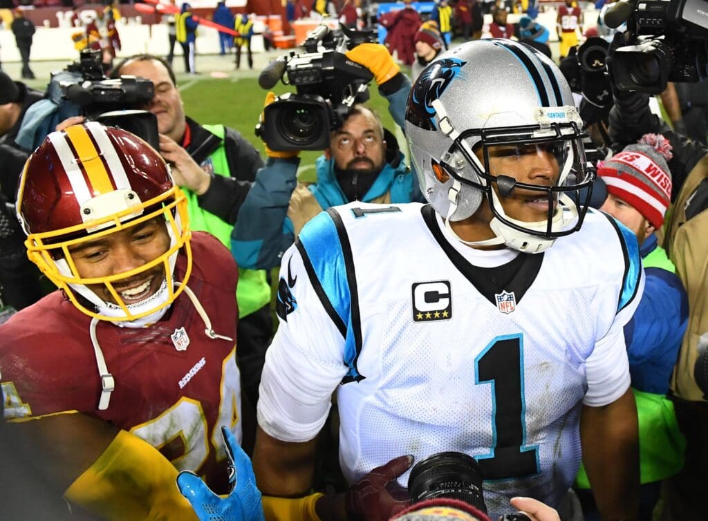 Dec 19, 2016; Landover, MD, USA; Carolina Panthers quarterback Cam Newton (1) talks with Washington Redskins cornerback Josh Norman (24) after their game at FedEx Field.