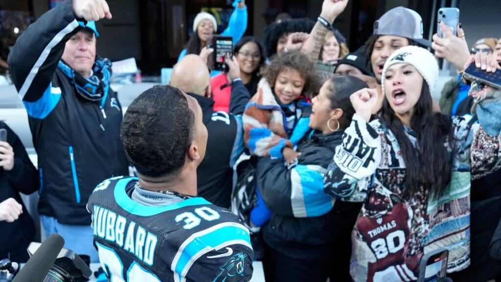 Dec 22, 2024; Charlotte, North Carolina, USA; Carolina Panthers running back Chuba Hubbard (30) celebreates with fans after scoring the game winning touchdown in overtime at Bank of America Stadium