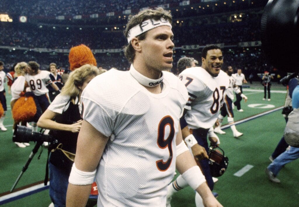 Jan 26, 1986; New Orleans, LA, USA; FILE PHOTO; Chicago Bears quarterback Jim McMahon (9), tight end Emery Moorehead (87) and teammates walk off the field after defeating the New England Patriots 46-10 to win Super Bowl XX at the Superdome.