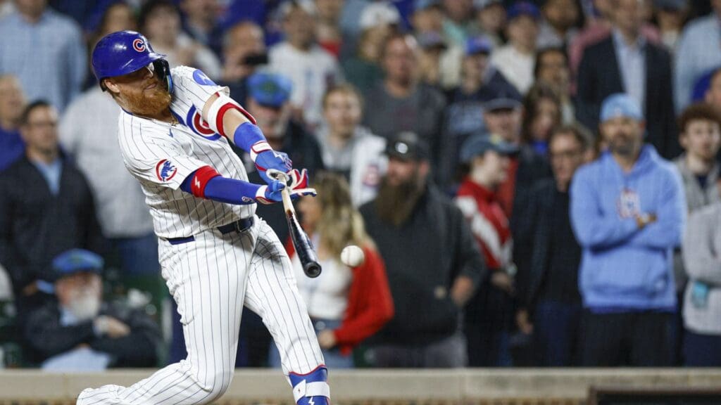 May 13, 2025; Chicago, Illinois, USA; Chicago Cubs first base Justin Turner (3) hits a walk-off two-run double against the Miami Marlins during the ninth inning at Wrigley Field.