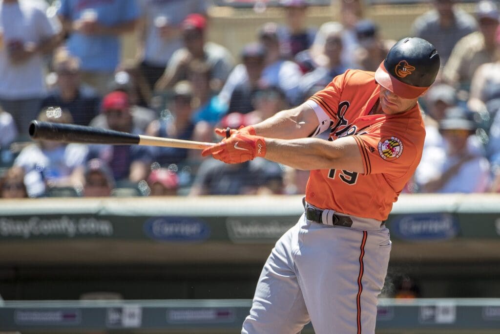 Jul 7, 2018; Minneapolis, MN, USA; Baltimore Orioles first baseman Chris Davis (19) hits a two run home run in the first inning against the Minnesota Twins at Target Field.