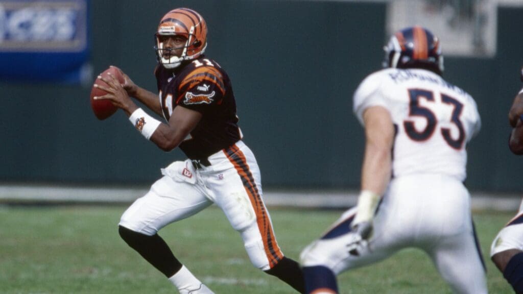 Oct 22, 2000; Cincinnati, OH, USA; Cincinnati Bengals quarterback Akili Smith (11) scrambles with the ball during the game against Denver Broncos linebacker Bill Romanowski (53) at Paul Brown Stadium. The Bengals beat the Broncos 31-21.