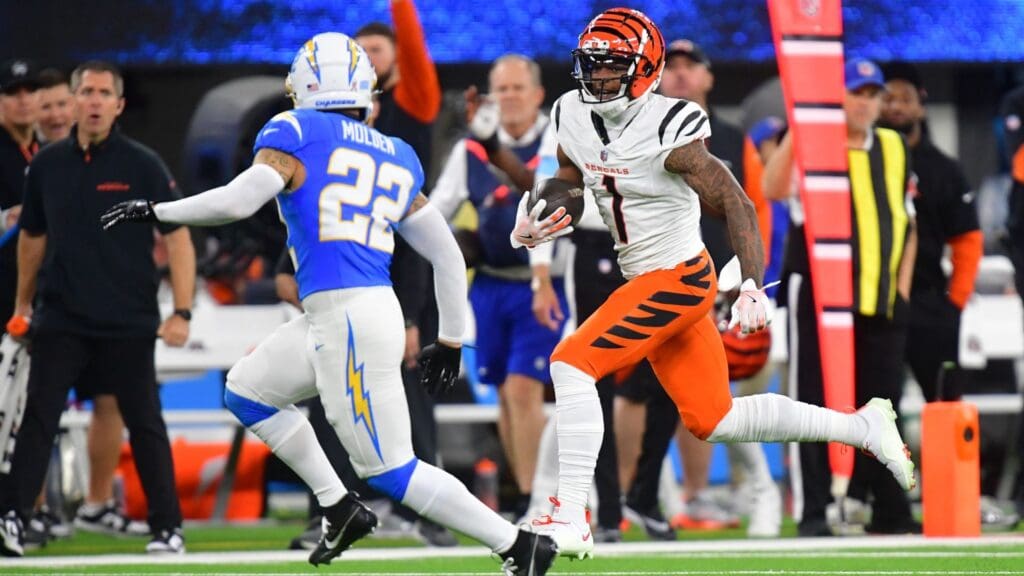Nov 17, 2024; Inglewood, California, USA; Cincinnati Bengals wide receiver Ja’Marr Chase (1) runs the ball against Los Angeles Chargers cornerback Elijah Molden (22) during the first half at SoFi Stadium.