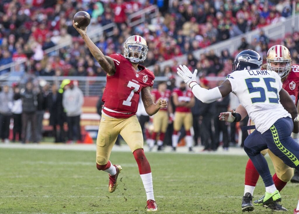 Jan 1, 2017; Santa Clara, CA, USA; San Francisco 49ers quarterback Colin Kaepernick (7) passes the football against Seattle Seahawks defensive end Frank Clark (55) during the fourth quarter at Levis Stadium Seahawks defeated the 49ers 25-23.