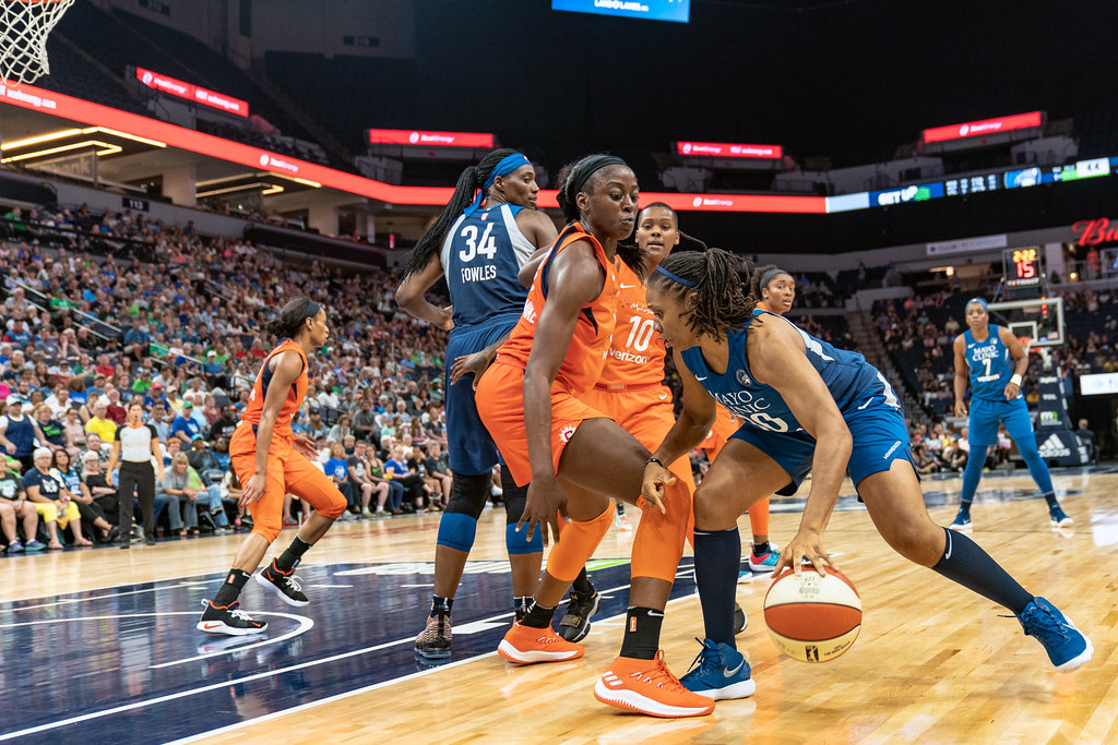 Tanisha Wright (30) looks for an opening as she's guarded by Chiney Ogwumike (13) in the Lynx vs Sun game at Target Center, the Connecticut Sun won 83-64