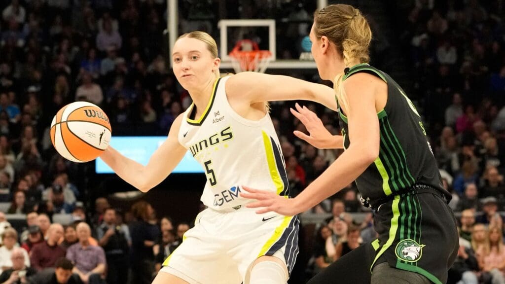 May 21, 2025; Minneapolis, Minnesota, USA; Dallas Wings guard Paige Bueckers (5) passes against Minnesota Lynx forward Alanna Smith (8) in the second quarter at Target Center