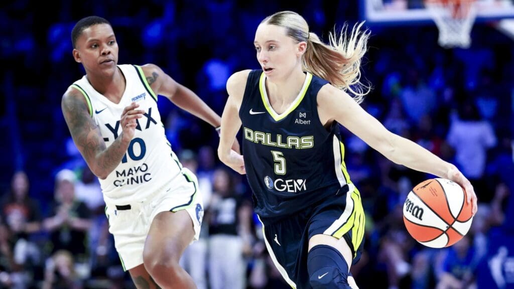 May 16, 2025; Arlington, Texas, USA; Dallas Wings guard Paige Bueckers (5) dribbles as Minnesota Lynx guard Courtney Williams (10) defends during the second half at College Park Center.