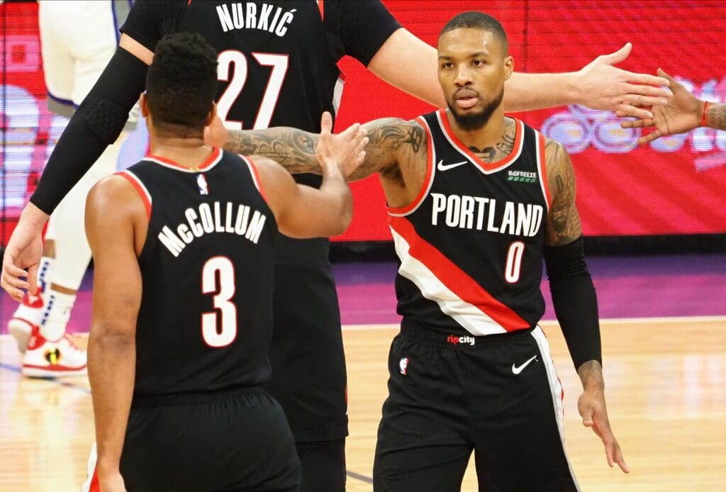 Portland Trail Blazers guard CJ McCollum (3) high fives guard Damian Lillard (0) as a timeout is called during the third quarter against the Sacramento Kings at Golden 1 Center.