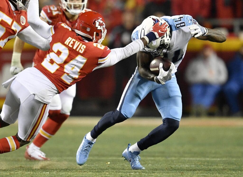 Jan 6, 2018; Kansas City, MO, USA; Tennessee Titans wide receiver Corey Davis (84) is grabbed by Kansas City Chiefs defensive back Darrelle Revis (24) in the second half in the AFC Wild Card playoff football game at Arrowhead Stadium. Mandatory Credit: Andrew Nelles/The Tennessean via USA TODAY Sports