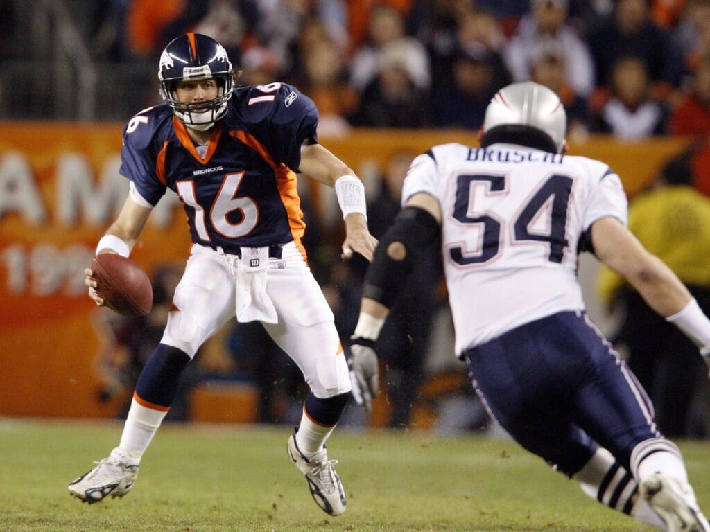Jan 14, 2006; Denver, CO, USA; Denver Broncos quarterback (16) Jake Plummer scrambles against New England Patriots linebacker (54) Tedy Bruschi in the first quarter during AFC Divisional Playoff game at Invesco Field at Mile High.