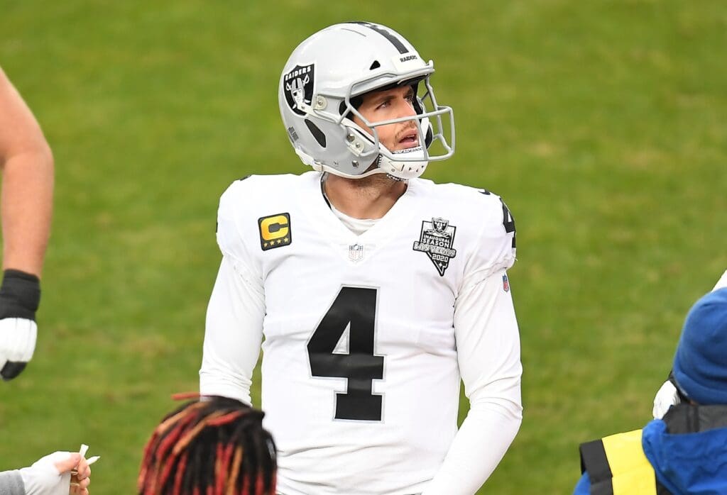 Jan 3, 2021; Denver, Colorado, USA; Las Vegas Raiders quarterback Derek Carr (4) following a series in the first quarter against the Denver Broncos at Empower Field at Mile High.