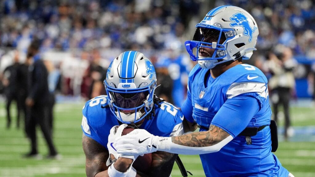 Detroit Lions running back Jahmyr Gibbs (26) warms up with running back David Montgomery (5) before the NFC divisional round at Ford Field in Detroit on Saturday, Jan. 18, 2025