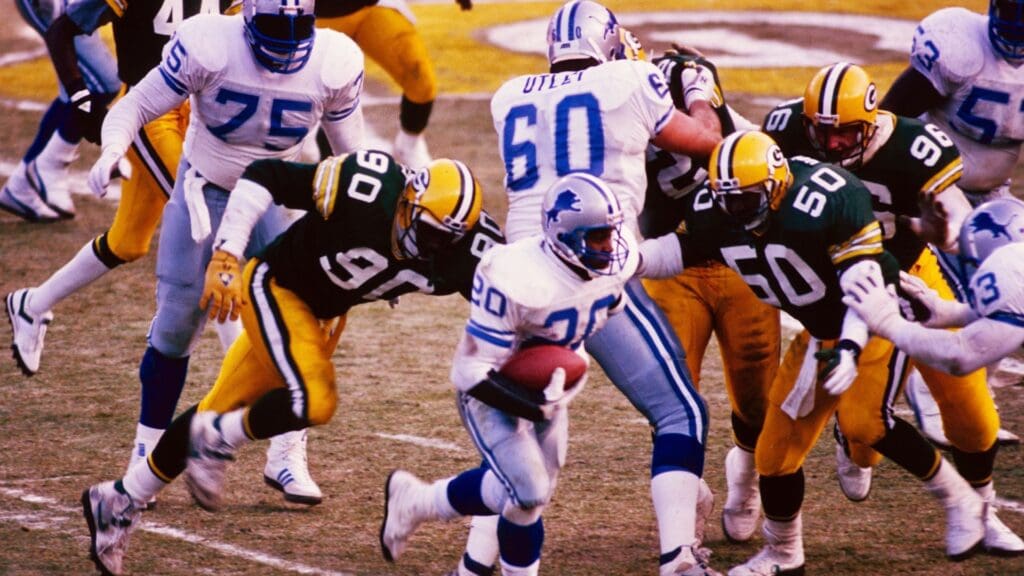 Unknown Date; Green Bay, WI, USA; FILE PHOTO; Detroit Lions running back Barry Sanders (20) carries the ball against Green Bay Packers linebackers Tony Bennett (90) and Johnny Holland (50) at Lambeau Field. 