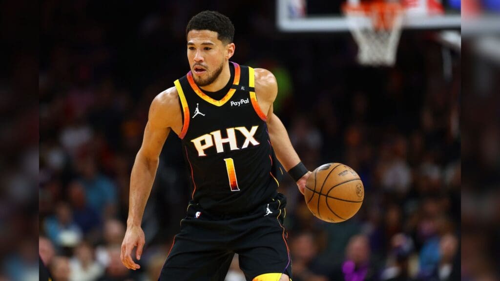 Apr 9, 2025; Phoenix, Arizona, USA; Phoenix Suns guard Devin Booker (1) dribbles the ball against the Oklahoma City Thunder during the first half at Footprint Center.