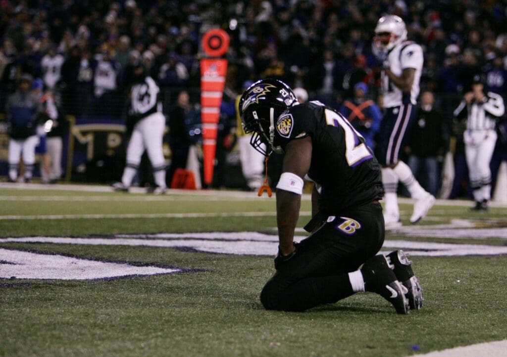 Dec 3, 2007; Baltimore, MD, USA; Baltimore Ravens safety Ed Reed (20) kneels on the ground after the cornerback Jamaine Winborne (28) committed a defensive holding penalty on the previous play which resulted in the first down for New England and led to the New England Patriots game-winning touchdown on the next play in the fourth quarter at M&T Bank Stadium. New England won the game 27-24. Mandatory Credit: James Lang-USA TODAY Sports