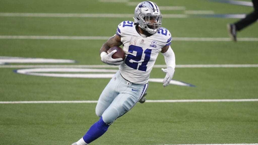 Dec 27, 2020; Arlington, Texas, USA; Dallas Cowboys running back Ezekiel Elliott (21) runs the ball in the second quarter against the Philadelphia Eagles at AT&T Stadium.