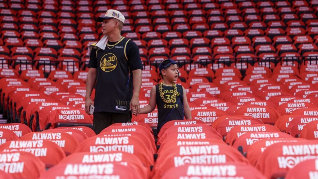 Fans watch the Golden State Warriors and Houston Rockets warm up before game five of first round for the 2025 NBA Playoffs at Toyota Center.