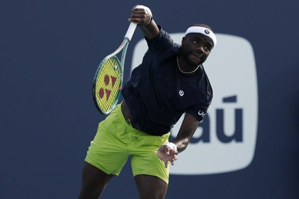 Caption:
Mar 24, 2025; Miami, FL, USA; Frances Tiafoe (USA) serves against Arthur Fils (FRA)(not pictured) on day seven of the Miami Open at Hard Rock Stadium.