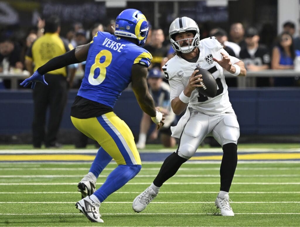 Oct 20, 2024; Inglewood, California, USA; Las Vegas Raiders quarterback Gardner Minshew (15) is chased by Los Angeles Rams linebacker Jared Verse (8) at SoFi Stadium. Mandatory Credit: Robert Hanashiro-Imagn Images