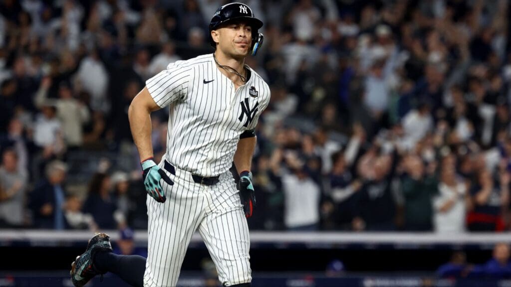 Oct 30, 2024; New York, New York, USA; New York Yankees designated hitter Giancarlo Stanton (27) reacts after hitting a home run during the third inning against the Los Angeles Dodgers in game five of the 2024 MLB World Series at Yankee Stadium.