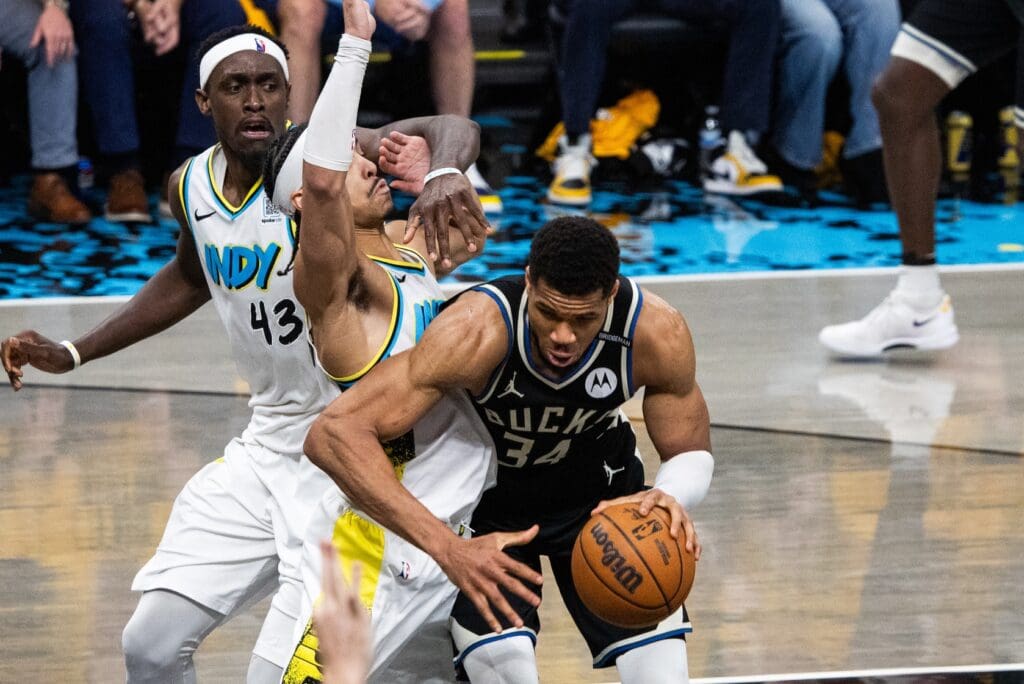 Apr 29, 2025; Indianapolis, Indiana, USA; Milwaukee Bucks forward Giannis Antetokounmpo (34) dribbles the ball while Indiana Pacers guard Andrew Nembhard (2) defends during game five of the first round for the 2024 NBA Playoffs at Gainbridge Fieldhouse. Mandatory Credit: Trevor Ruszkowski-Imagn Images