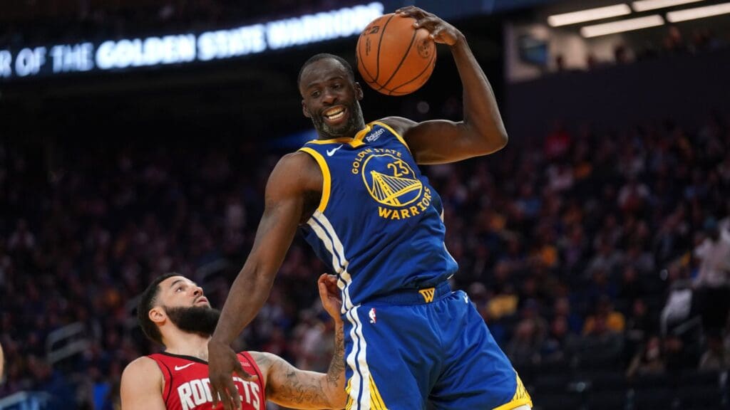 Apr 6, 2025; San Francisco, California, USA; Golden State Warriors forward Draymond Green (23) holds onto a rebound in front of Houston Rockets guard Fred VanVleet (5) in the third quarter at the Chase Center.